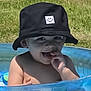 Luka joined the competition — help win amazing prizes! toddler, child, bucket_hat, smiling, tongue_out, inflatable_pool, water, summer, outdoor, grass, playful, bare_shoulders, cute, happy, sunny, baby, person, fun, hat, closeup