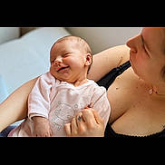 Loïs participe au concours pour gagner de l'argent avec cette photo : baby, smiling, infant, sleeping, pink_clothing, bear_print, arm, adult, love, care, tenderness, portrait, indoor, closeup, skin, person, holding, comfort, cute, happy