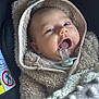 Loïs a rejoint le concours — aidez-le/la à gagner de superbes lots ! baby, pacifier, hoodie, blanket, infant, face, child, cute, soft_texture, cozy, warm_clothing, portrait, closeup, indoor, person, newborn, expression, wrapped, seat, comfort