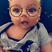 Aaron participe au concours pour gagner de l'argent avec cette photo : baby, child, filter, bear_ears, glasses, hearts, mickey_mouse, shirt, blue_cushion, cute, infant, face, portrait, expression, indoor, smile, young_child, clothing, person, digital_filter
