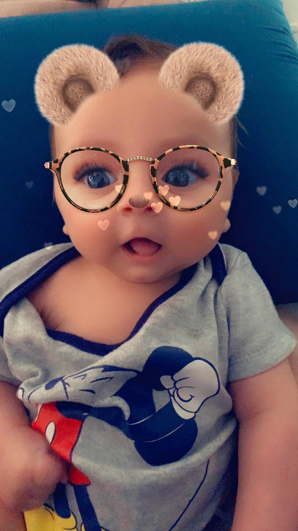 Aaron participe au concours pour gagner de l'argent avec cette photo : baby, child, filter, bear_ears, glasses, hearts, mickey_mouse, shirt, blue_cushion, cute, infant, face, portrait, expression, indoor, smile, young_child, clothing, person, digital_filter
