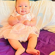 Ember joined the competition — help win amazing prizes! baby, infant, pink_dress, tongue_out, purple_bedspread, pillow, wooden_headboard, cute, smiling, sitting, indoors, child, soft_lighting, barefoot, chubby_cheeks, happy, portrait, tulle_skirt, relaxed, cozy