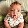 Ember joined the competition — help win amazing prizes! baby, infant, face, eyes, hands, clothing, pillow, blanket, soft, cute, indoor, person, portrait, child, young, closeup, expression, cute_face, curious, skin