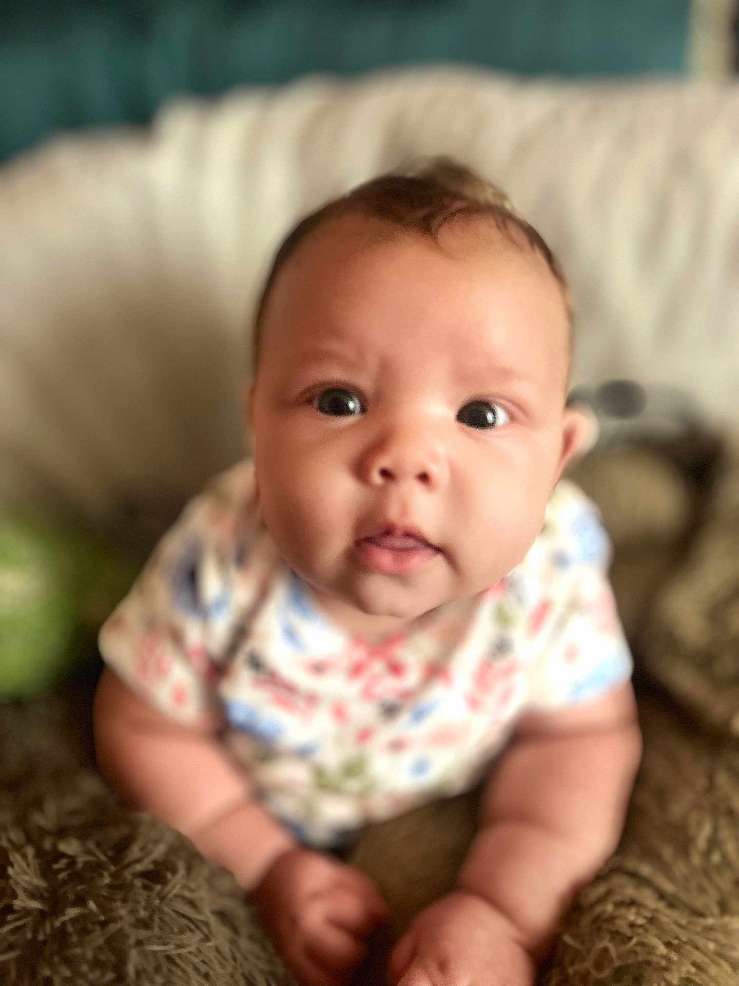 Ember joined the competition — help win amazing prizes! baby, infant, face, eyes, hands, clothing, pillow, blanket, soft, cute, indoor, person, portrait, child, young, closeup, expression, cute_face, curious, skin