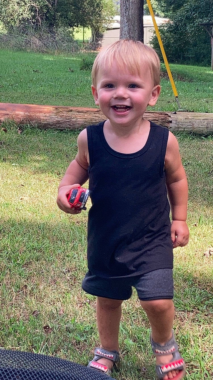 Judson joined the competition — help win amazing prizes! baby_toddler_clothing, child, clothing, finger, fun, gesture, grass, happy, head, joy, lawn, people_in_nature, person, plant, recreation, sleeve, smile, standing, summer, t_shirt