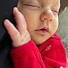 Elliot joined the competition — help win amazing prizes! newborn, baby, infant, sleeping, portrait, close_up, red_outfit, onesie, hand, face, eyes_closed, peaceful, cozy, indoors, soft_lighting, sitting, cuddled, text_on_clothing, cute, photography