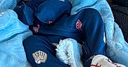 Elliot is registered to the contest to win money with this photo: newborn, baby, sleeping, infant, face, portrait, car_seat, blanket, blue_blanket, blue_clothing, baseball, baseball_socks, socks, bundled, cozy, indoors, vehicle, peaceful, photography, child