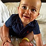 baby, child, smiling, sitting, navy_blue_shirt, anchor, bed, white_bedspread, feet, hands, happy, cute, infant, portrait, indoors, closeup, skin, expression, person, young_child