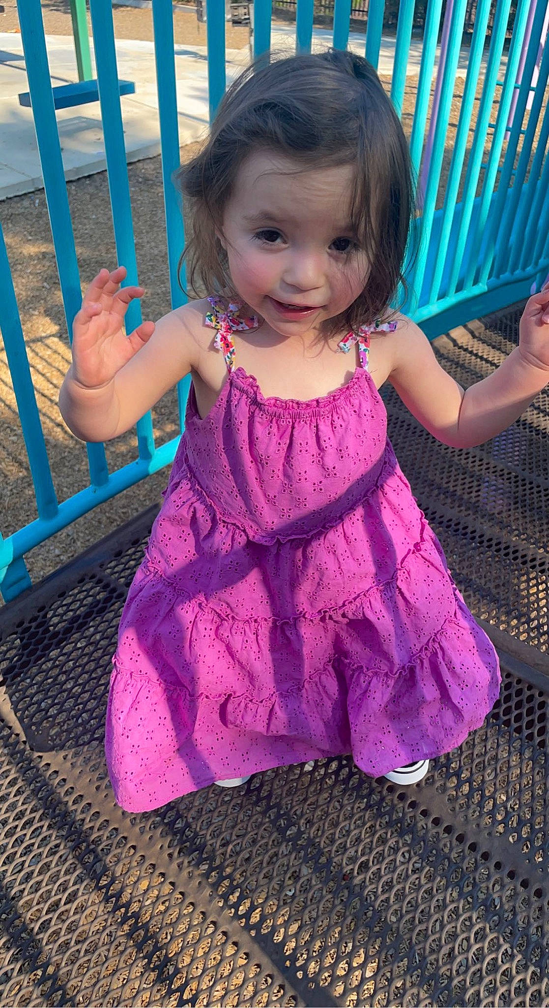 Danielle is registered to the contest to win money with this photo: arm, baby, baby_toddler_clothing, cheek, dress, face, finger, hairstyle, hand, happy, head, iris, person, pink, purple, skin, sleeve, smile, standing, toddler