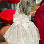 dog, small_dog, white_dress, bow, sequin, pet, lap, red_chair, indoor, fur, cute, animal, side_view, person, sitting, cozy, domestic, companion, cute_pet, fashion