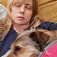 Sandy joined the competition — help win amazing prizes! blonde_hair, casual_clothing, closed_eyes, closeup, comfort, companion, couch, cozy, dog, friendship, fur, home, indoor, pet, pink_harness, portrait, relaxation, resting, sleeping, woman