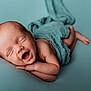newborn, baby, sleeping, smiling, wrapped, blue_background, infant, cute, peaceful, soft_texture, portrait, child, skin, lying_down, tiny, happy, head, arm, hand, foot