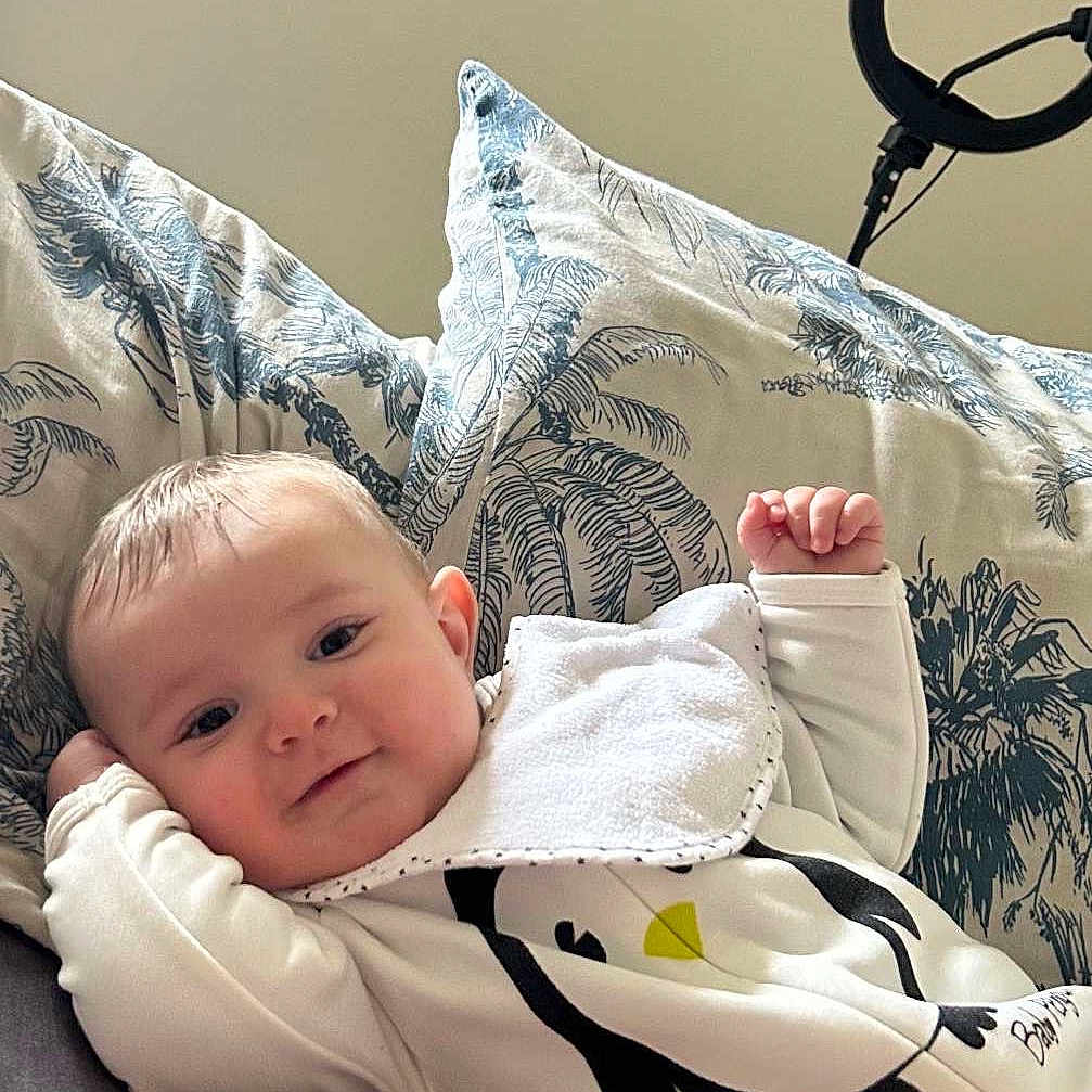 Ayden participe au concours pour gagner de l'argent avec cette photo : baby, bed, bedroom, blanket, clothing, cushion, face, furniture, head, homedecor, indoors, newborn, pants, person, photography, pillow, portrait, room, sitting, sleeve