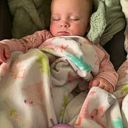 Elle is registered to the contest to win money with this photo: baby, infant, sleeping, blanket, swaddle, bottle, onesie, closed_eyes, peaceful, cozy, soft_texture, portrait, car_seat, hand, cheeks, head, eyelashes, nursery, sleepwear, pink