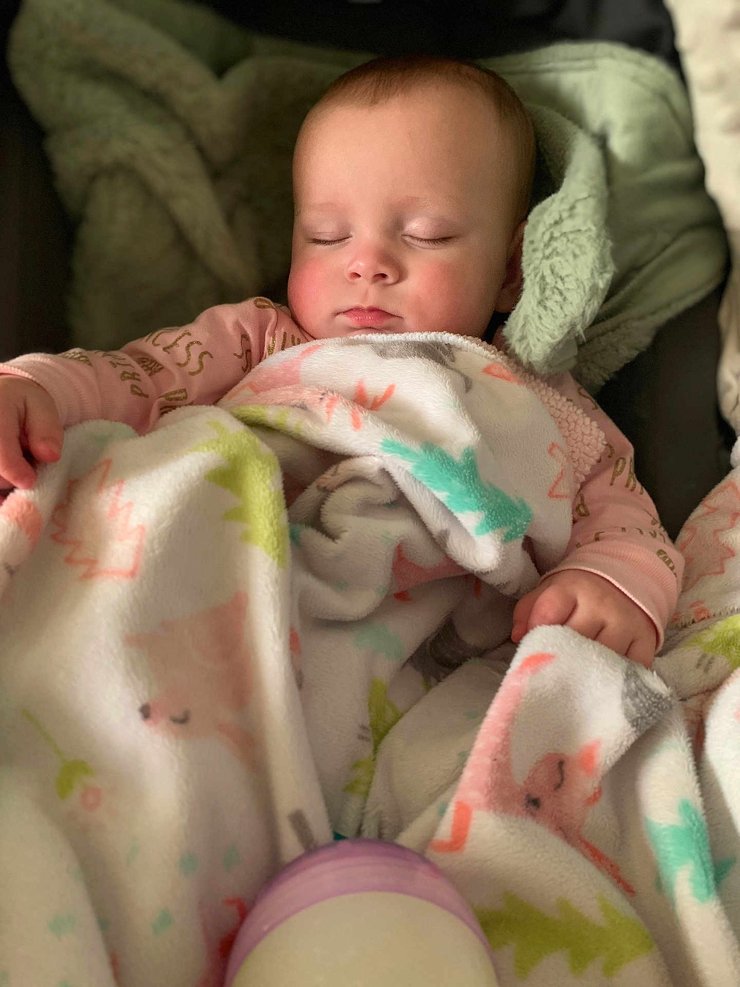 Elle is registered to the contest to win money with this photo: baby, infant, sleeping, blanket, swaddle, bottle, onesie, closed_eyes, peaceful, cozy, soft_texture, portrait, car_seat, hand, cheeks, head, eyelashes, nursery, sleepwear, pink