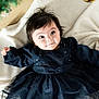 baby, child, infant, dress, navy_blue, blanket, face, eyes, hair, indoor, cute, adorable, holiday, ornaments, decorations, smile, lying_down, soft_texture, warm, cozy