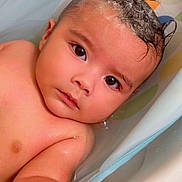 Santos is registered to the contest to win money with this photo: baby, child, bathtub, water, foam, shampoo, mohawk, skin, arm, hand, face, eyes, expression, cute, infant, bath, bathroom, wet, relaxed, portrait