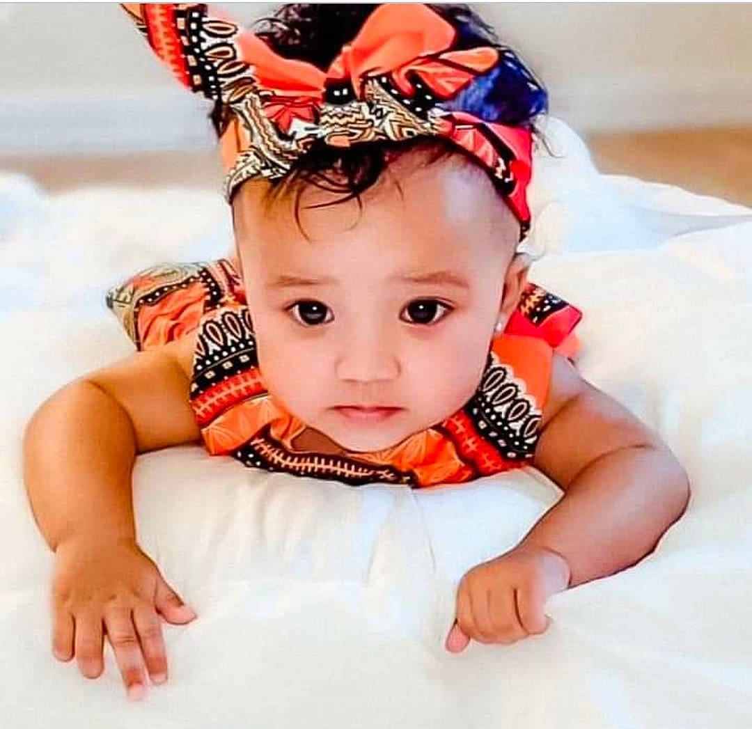 Giselle joined the competition — help win amazing prizes! baby, baby_products, baby_toddler_clothing, cap, child, costume_hat, ear, eyelash, fashion_accessory, hair_accessory, hair_tie, happy, headband, headgear, headpiece, jewellery, neck, pattern, person, sleeve