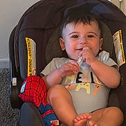 Soufain joined the competition — help win amazing prizes! baby, car_seat, carpet, child, clothing, cute, face, feet, hand, happy, indoor, infant, person, plush_toy, shirt, sitting, smile, spiderman, toy, young_child