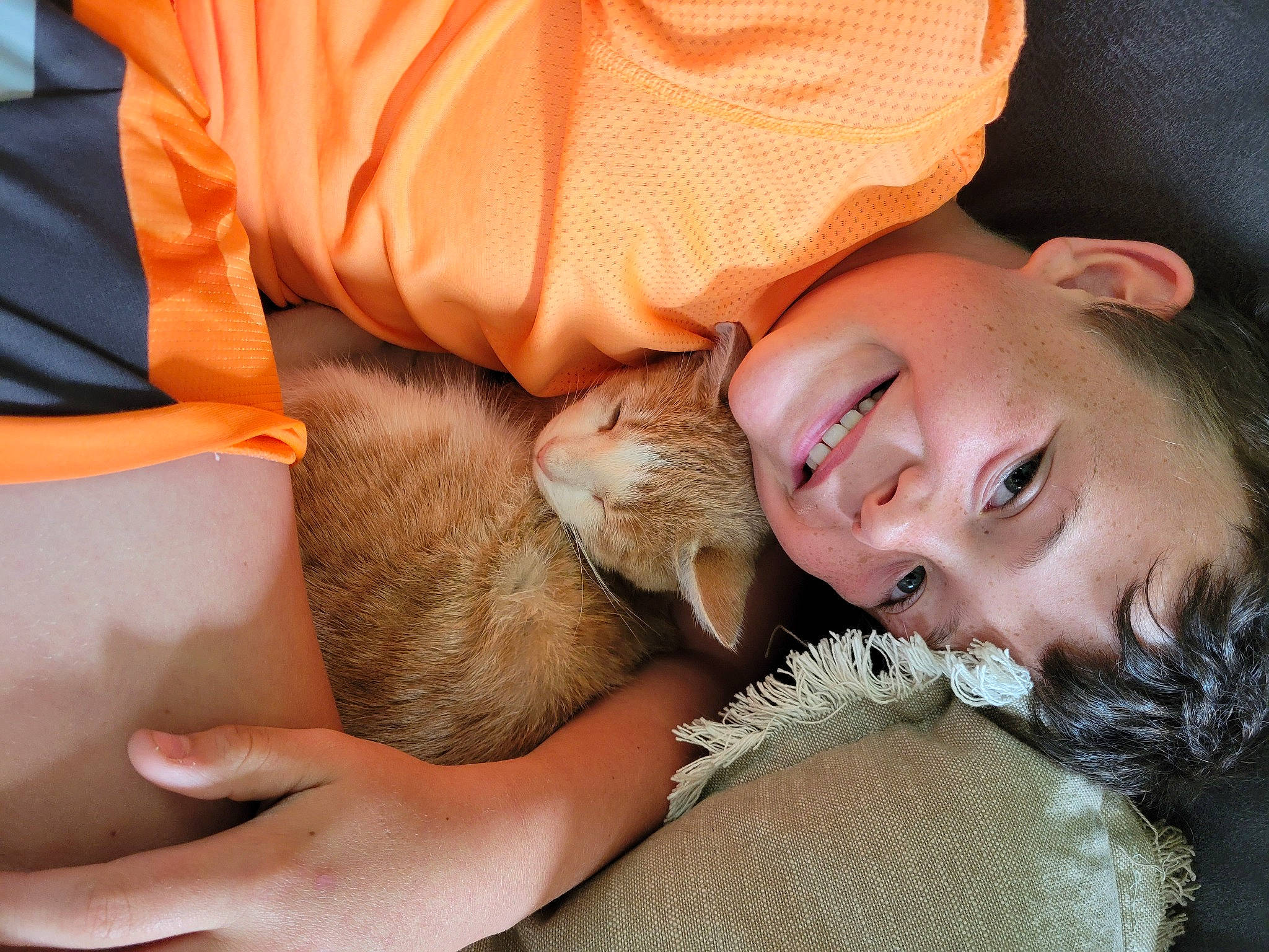 Jaxsyn is registered to the contest to win money with this photo: brown_hair, child, comfort, companion_dog, eyelash, fawn, felidae, finger, fur, gesture, happy, human_leg, joy, nail, nap, neck, person, sitting, skin, small_to_medium_sized_cats