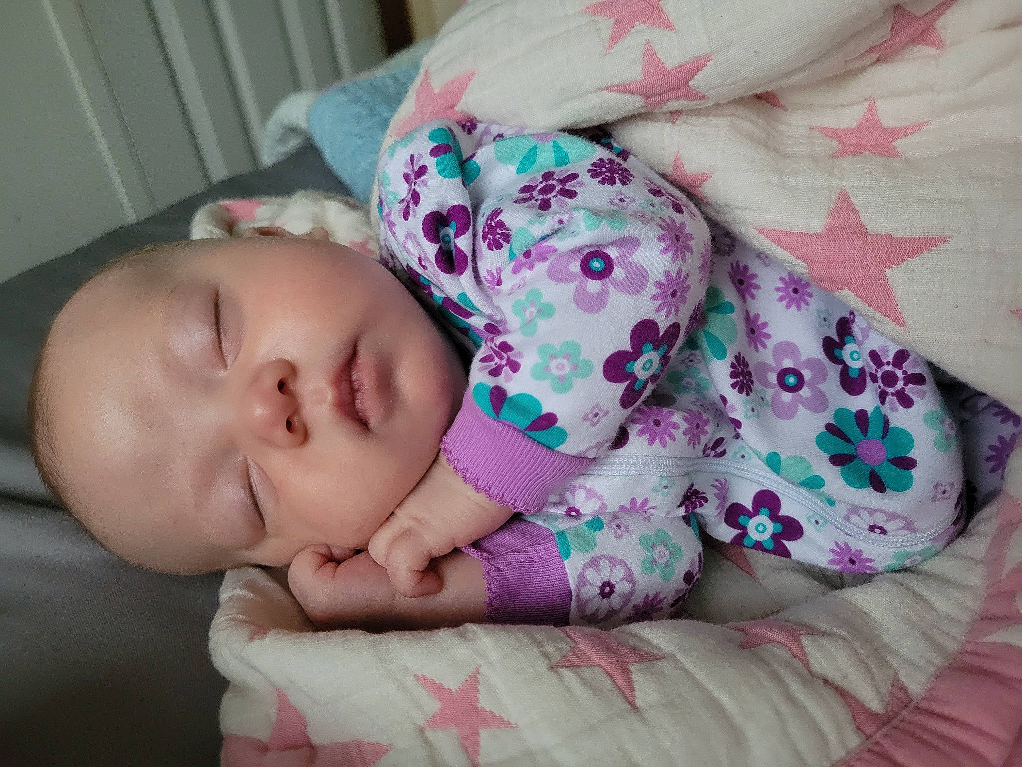 Iris Evelyn is registered to the contest to win money with this photo: baby, baby_toddler_clothing, bedtime, cheek, child, comfort, face, facial_expression, head, linens, lip, mammal, nose, pattern, person, pink, product, skin, sleeve, toddler