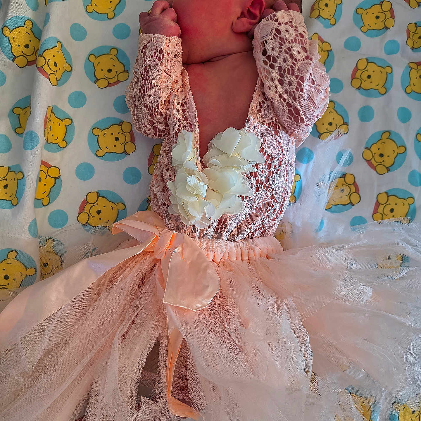 Ashlee is registered to the contest to win money with this photo: adorable, baby, baby_girl, blanket, cartoon, child, cute, fingers_in_mouth, flower, indoors, infant, lace, lying_down, newborn, pink_clothing, portrait, sleepy, soft_fabric, tutu, winnie_the_pooh