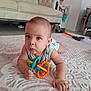 baby, background, carpet, child, clothing, couch, curious, expression, floor, furniture, hand, head, household, indoor, person, play, room, toddler, toy, vacuum_cleaner