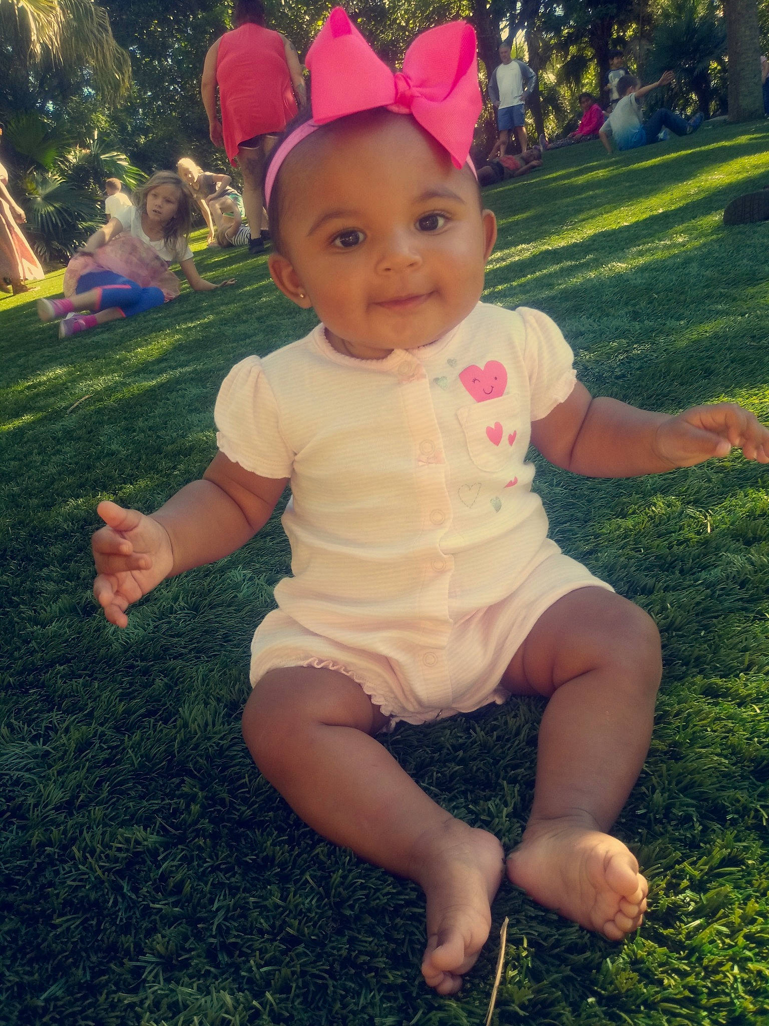 A'Vi is registered to the contest to win money with this photo: baby, child, ear, fawn, fun, grass, happy, headgear, leaf, leg, person, pink, plant, play, sitting, smile, summer, toddler, tree