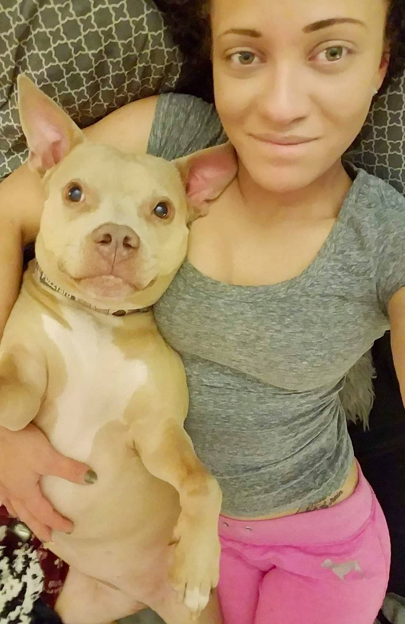 Sky is registered to the contest to win money with this photo: arm, carnivore, dog, dog_breed, ear, eye, face, facial_expression, hairstyle, head, human_body, muscle, neck, nose, organ, pink, skin, sleeve, smile, white