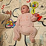 baby, cat_design, child, colorful, cozy, cute, family, floor, hand, happy, indoor, infant, lying_down, person, pink_onesie, play_mat, playtime, smiling, soft_toys, toys