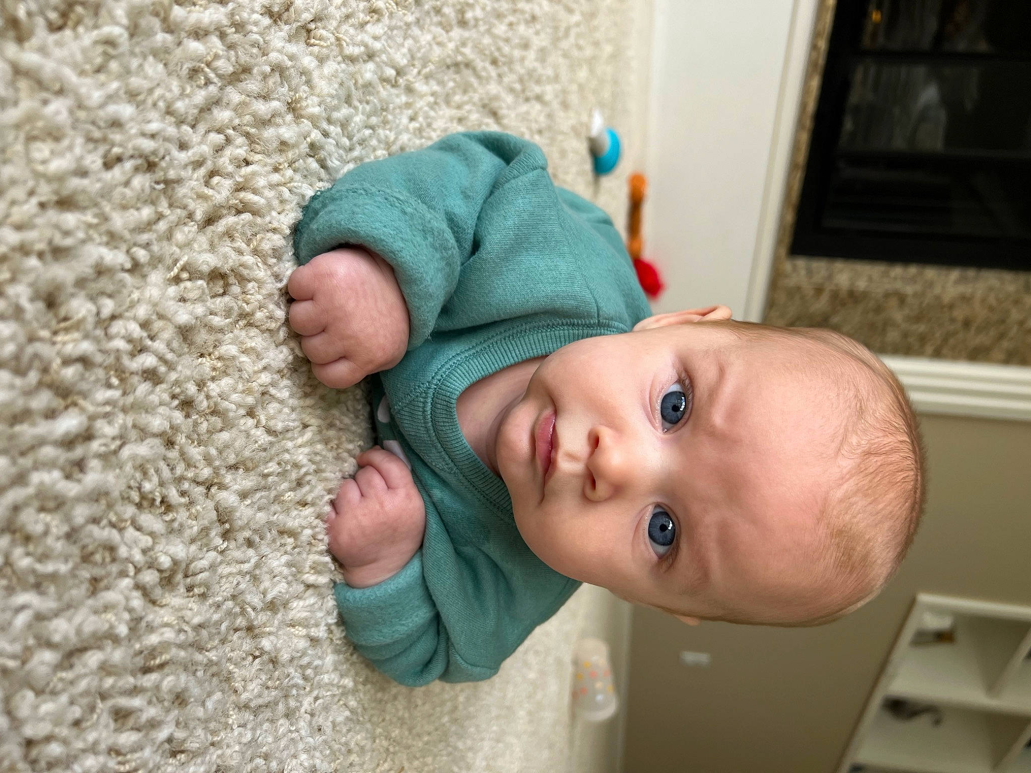 Bentley is registered to the contest to win money with this photo: baby, baby_toddler_clothing, cap, cheek, child, comfort, flooring, fur, happy, linens, lip, nose, person, portrait_photography, room, sitting, sleeve, smile, toddler, wood