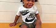 Tylin joined the competition — help win amazing prizes! toddler, child, smiling, curly_hair, afro, nike, sneakers, shorts, tshirt, bench, indoor, portrait, happy, young_child, casual_clothing, footwear, person, seated, cute, playful