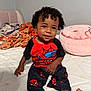 Tylin joined the competition — help win amazing prizes! toddler, child, curly_hair, smiling, pajamas, spiderman, bed, blanket, pillow, indoor, person, clothing, cute, feet, face, happy, home, young_child, sitting, cozy