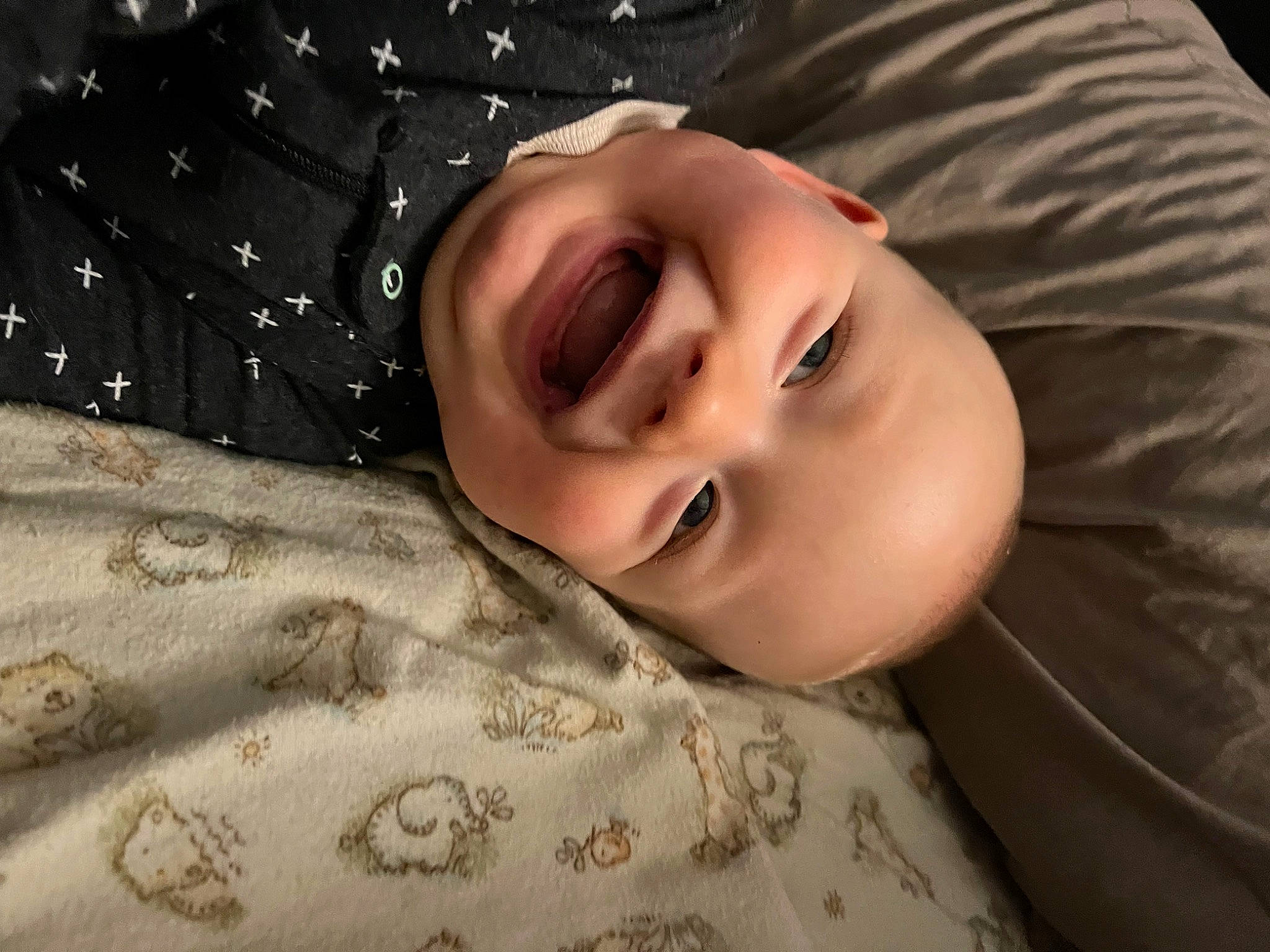 Zander is registered to the contest to win money with this photo: cheek, child, comfort, eyebrow, eyelash, flash_photography, fur, happy, hat, joy, linens, nose, pattern, person, portrait, portrait_photography, sleep, sleeve, smile, toddler