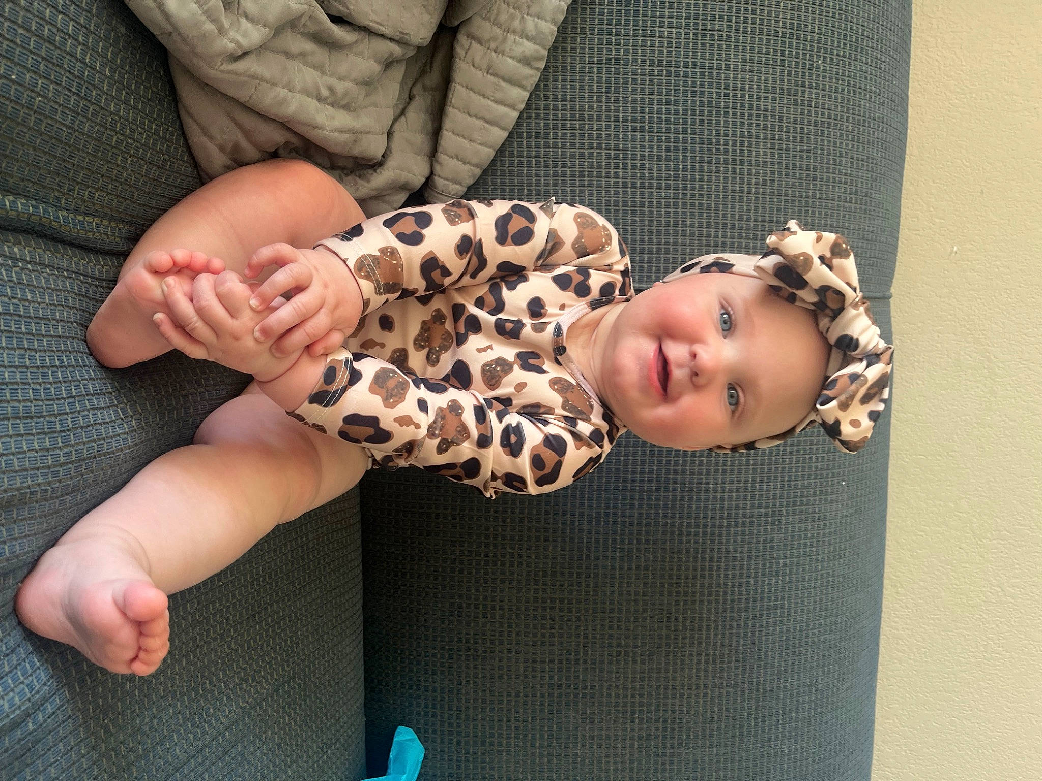 Brylee joined the competition — help win amazing prizes! baby, baby_toddler_clothing, child, comfort, fashion_accessory, finger, foot, gesture, headwear, human_body, human_leg, nail, pattern, person, sitting, skin, sleeve, smile, thigh, toddler