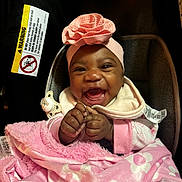 Myalinn is registered to the contest to win money with this photo: baby, smiling, pink_blanket, headband, flower, car_seat, infant, happy, child, clothing, pacifier, blanket, cute, portrait, indoors, hand, face, baby_girl, warm, cozy
