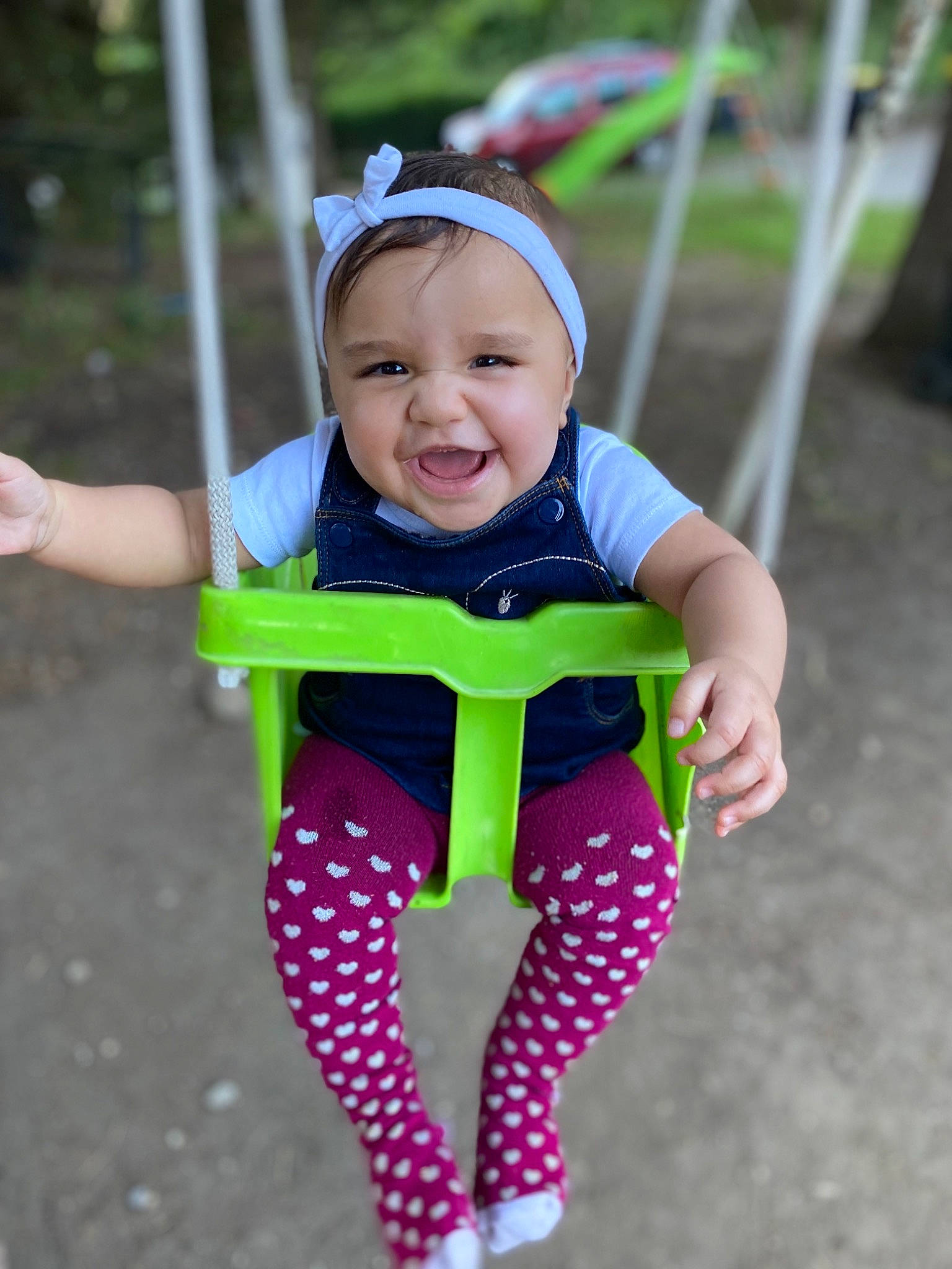 Keyla participe au concours pour gagner de l'argent avec cette photo : baby, baby_products, baby_toddler_clothing, child, design, fun, happy, headwear, outdoor_play_equipment, pattern, person, pink, play, product, skin, smile, swing, toddler