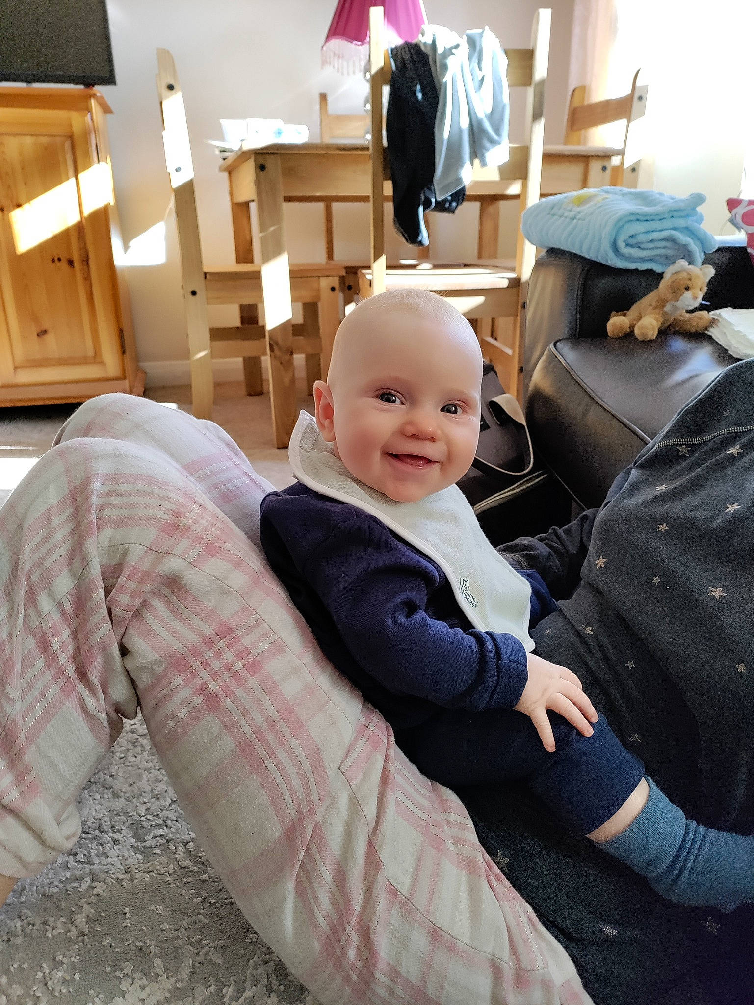 Sonny is registered to the contest to win money with this photo: baby, chair, chest_of_drawers, child, comfort, drawer, flooring, formal_wear, fun, happy, joy, lamp, luxury_vehicle, person, pillow, room, sitting, smile, suit, toddler