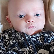 Skylar is registered to the contest to win money with this photo: baby, blanket, child, close_up, clothing, cute, expression, eyes, face, head, indoors, infant, newborn, pattern, person, portrait, skin, soft, warm, young