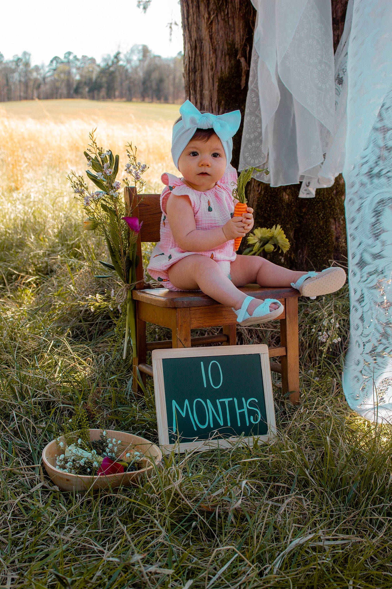 Evie is registered to the contest to win money with this photo: baby, chair, fun, grass, grass_family, grassland, happy, hat, headwear, landscape, leaf, leisure, people_in_nature, person, plant, recreation, sitting, soil, spring, sun_hat