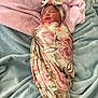 Anzal is registered to the contest to win money with this photo: newborn, baby, swaddle, headband, floral_pattern, blanket, pink, blue, soft_texture, sleeping, infant, cute, cozy, resting, portrait, wrapped, child, indoor, peaceful, closeup