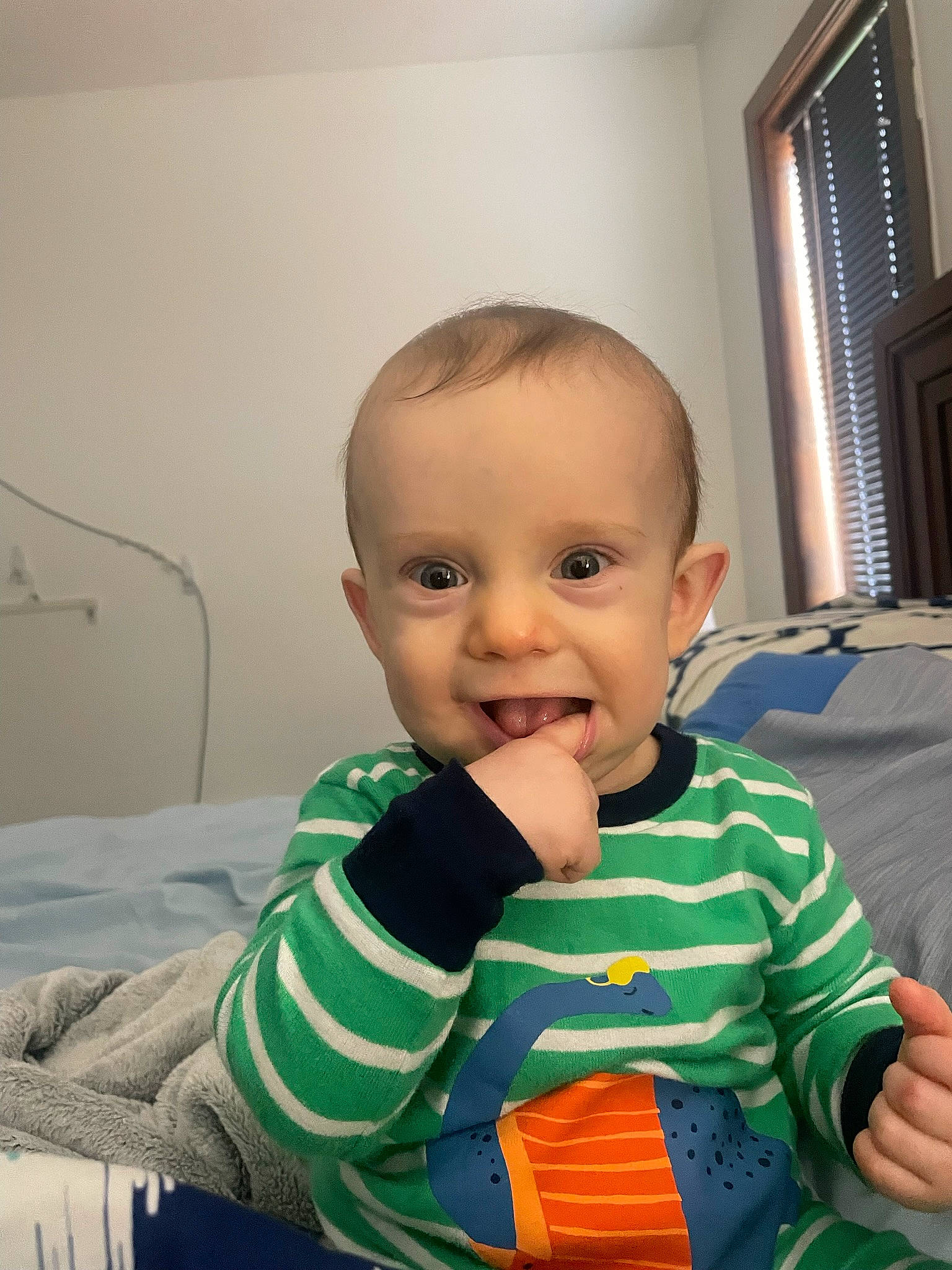 William is registered to the contest to win money with this photo: baby, baby_toddler_clothing, cheek, child, clothing, comfort, curtain, eye, fun, happy, joy, person, sitting, skin, sleeve, smile, standing, t_shirt, thumb, toddler
