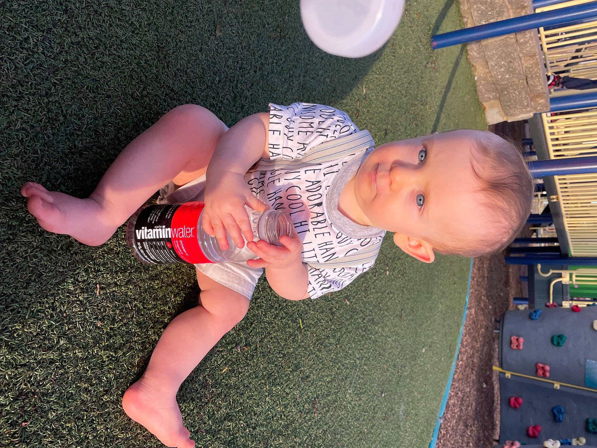 William is registered to the contest to win money with this photo: baby, calf, elbow, finger, flooring, foot, fun, grass, hand, human_body, human_leg, joint, knee, leg, leisure, person, smile, thigh, toddler, trunk