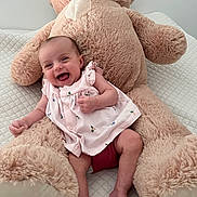 Mayline a rejoint le concours — aidez-le/la à gagner de superbes lots ! baby, child, comfort, cozy, cuddly, cute, happy, indoor, infant, laughing, person, pink_dress, plush_toy, quilted_blanket, seated, smiling, soft_toy, stuffed_animal, teddy_bear, toy