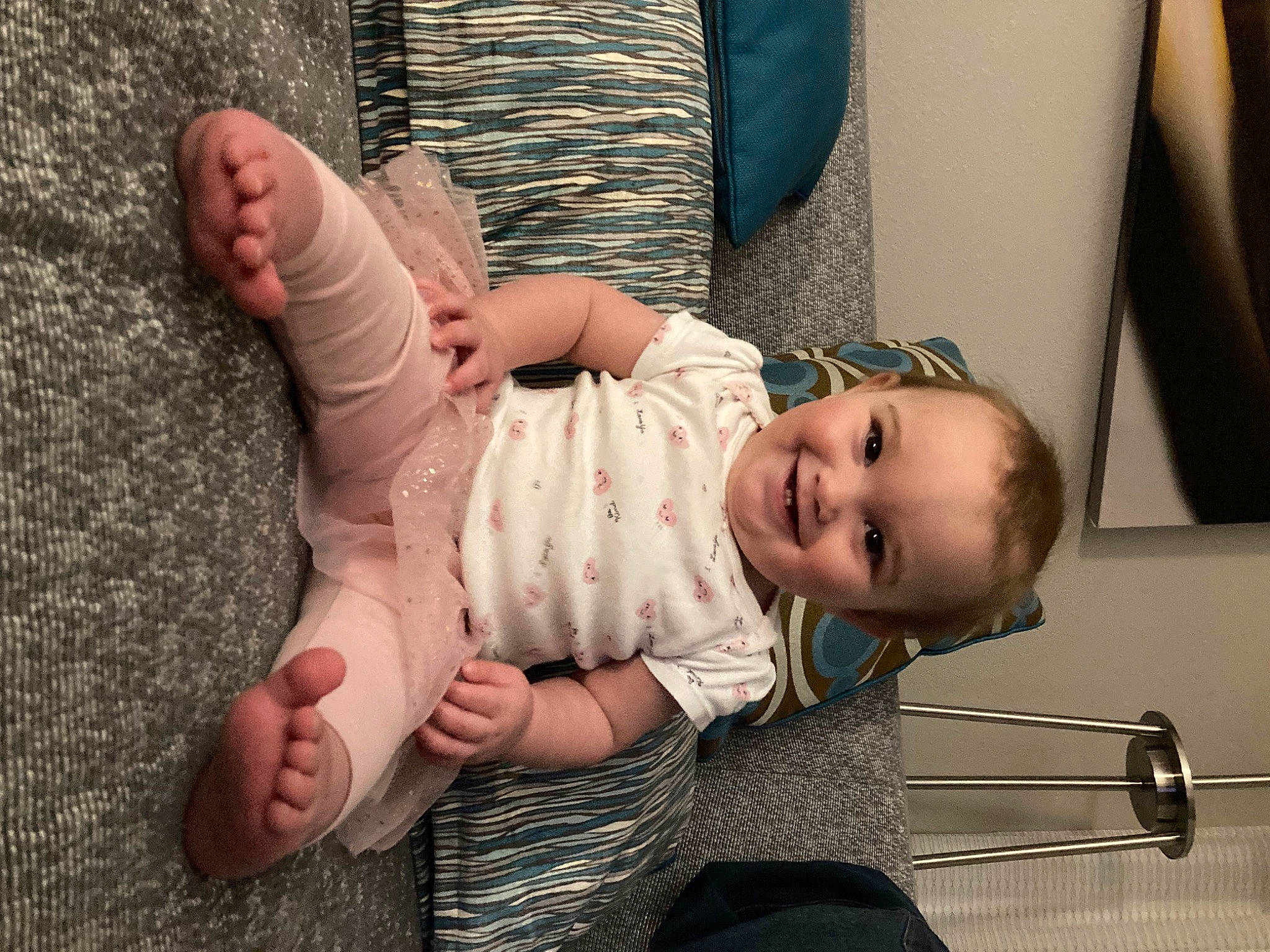 Kendall is registered to the contest to win money with this photo: baby, baby_toddler_clothing, barefoot, cheek, comfort, eye, finger, foot, gesture, hand, happy, head, human_body, joint, joy, leg, mouth, person, skin, smile