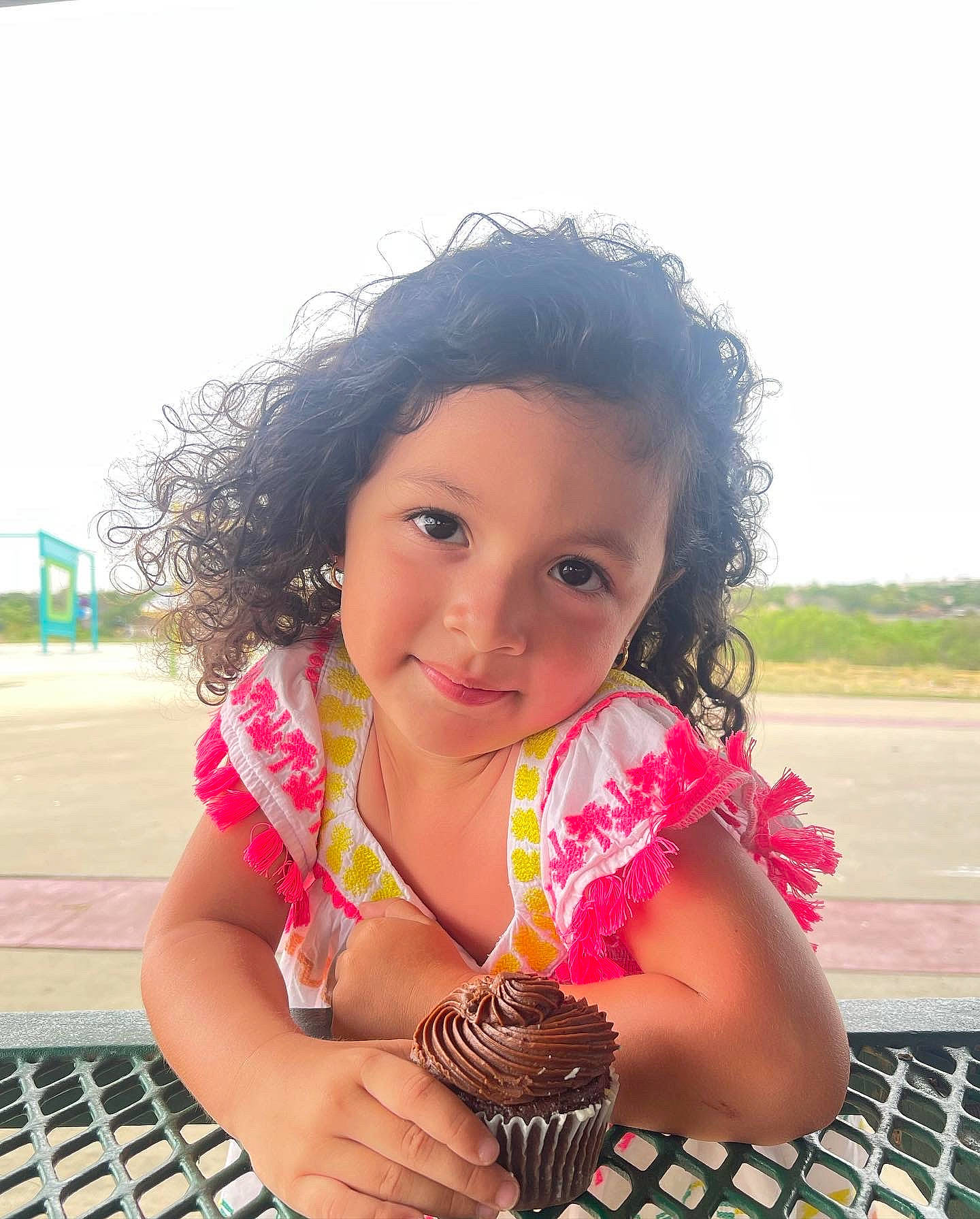 Ximena is registered to the contest to win money with this photo: black_hair, child, dessert, fun, grass, hairstyle, happy, joy, leisure, magenta, person, pink, plant, recreation, sitting, sky, smile, sweetness, thigh, toddler