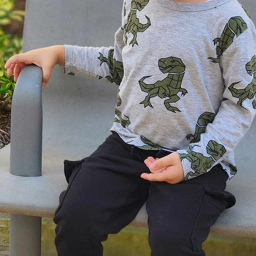 ömer Alp joined the competition — help win amazing prizes! child, boy, toddler, smiling, happy, portrait, seated, chair, playground, outdoor, dinosaur, shirt, long_sleeves, pants, sneakers, curly_hair, fashion, person, daylight, playful