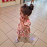 Elif is registered to the contest to win money with this photo: child, toddler, girl, floral_dress, sunglasses, hair_bun, earrings, bracelet, shoes, standing, side_profile, smiling, indoor, shopping_mall, tiled_floor, glass_doors, fashion, portrait, polka_dot_display, casual_photography