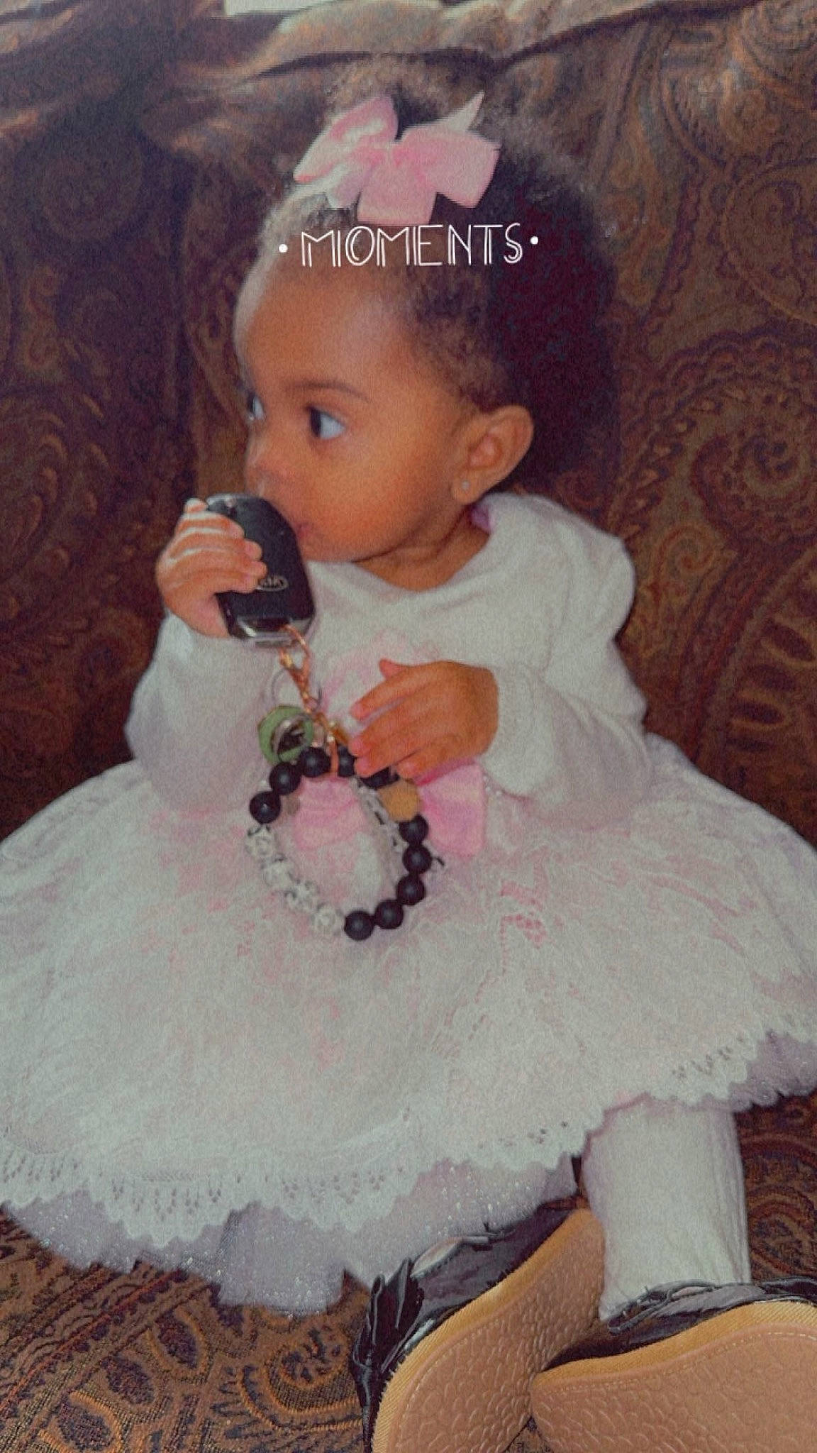 Isis is registered to the contest to win money with this photo: baby, baby_toddler_clothing, cheek, child, day_dress, dress, embellishment, event, face, hairstyle, hand, happy, head, iris, person, pink, ruffle, sitting, skin, sleeve