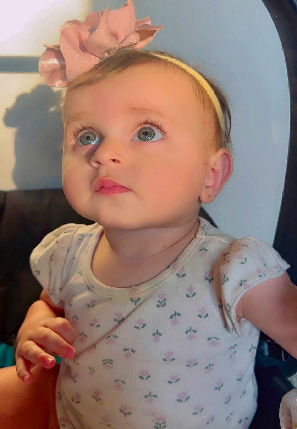 Seela joined the competition — help win amazing prizes! baby, child, girl, headband, bow, blue_eyes, cute, infant, portrait, soft_light, pink, floral_pattern, shirt, sitting, indoors, earring, skin, face, expression, adorable